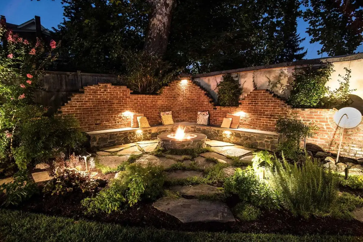 Outdoor fireplace with stone patio by Evergreen Hardscaping
