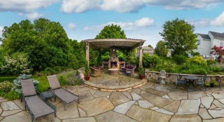 Natural stone retaining wall and patio by Evergreen Hardscaping