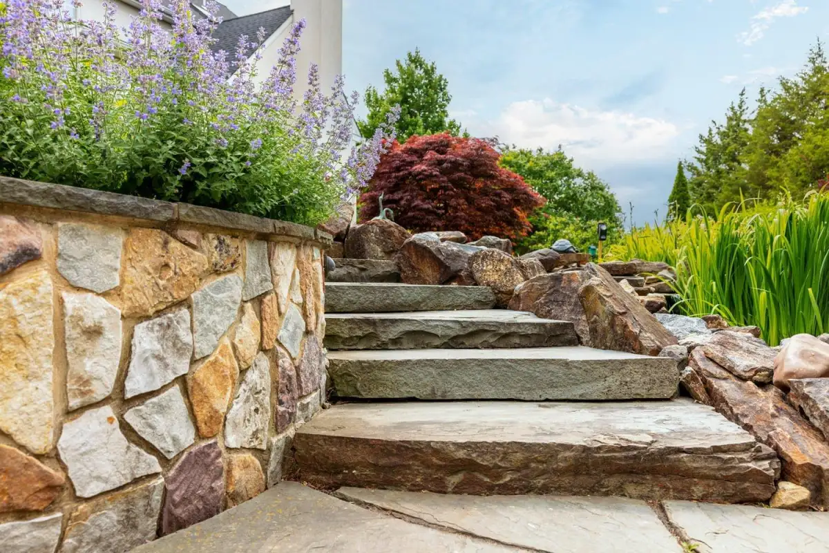 Multi-tier retaining wall with integrated steps and plantings