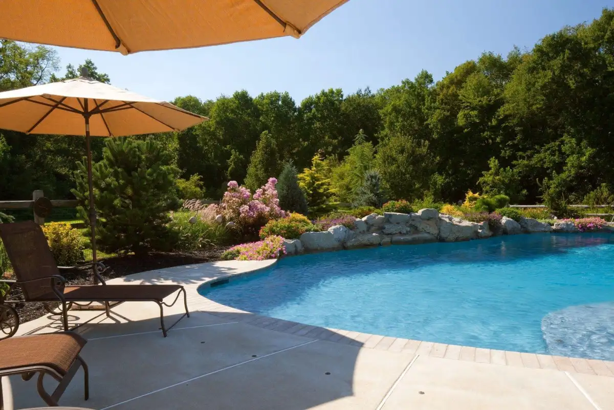 Completed outdoor living space with patio, fire feature, and landscaping by Evergreen Hardscaping
