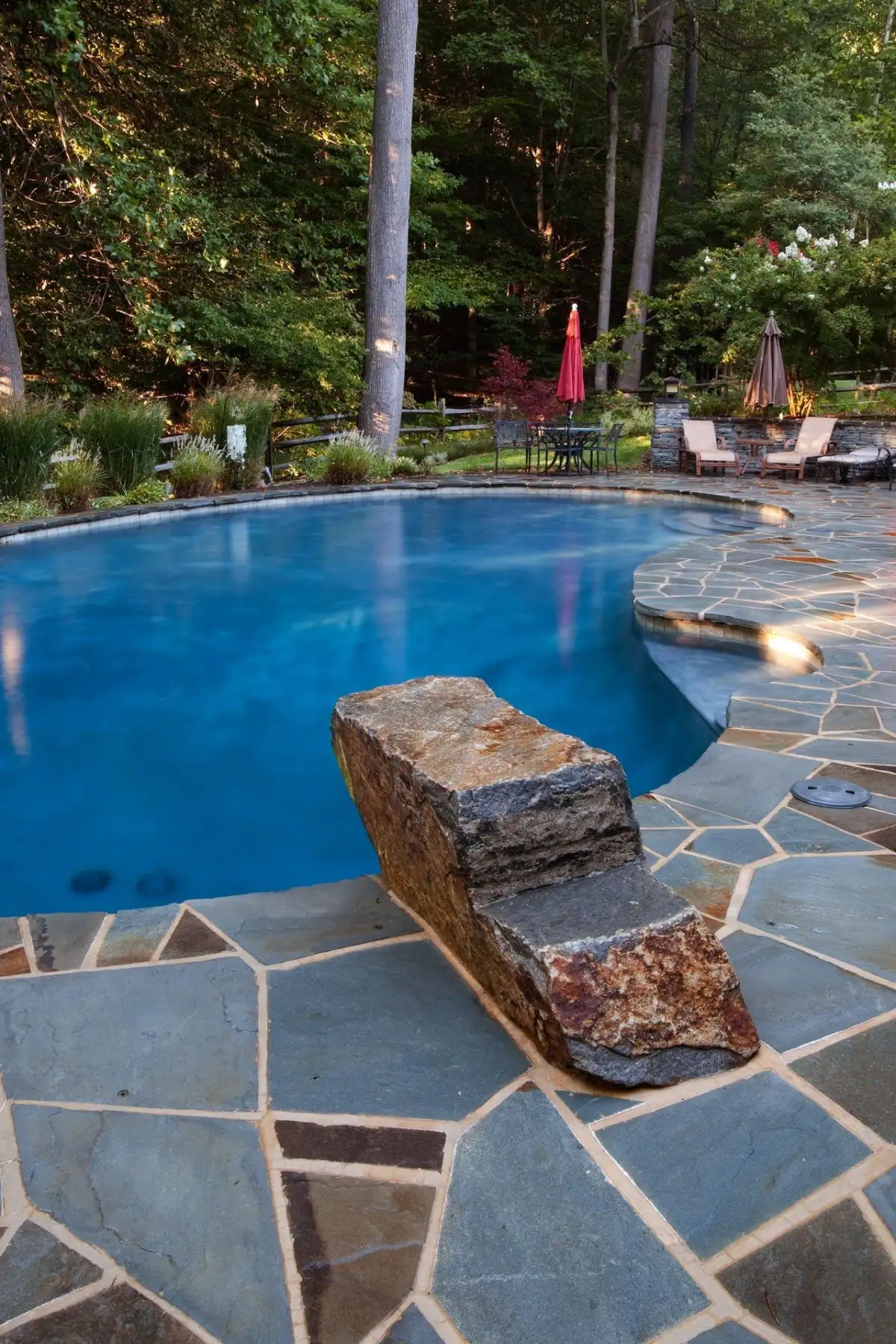 Multi-tier natural stone retaining wall with integrated plantings in Delaware