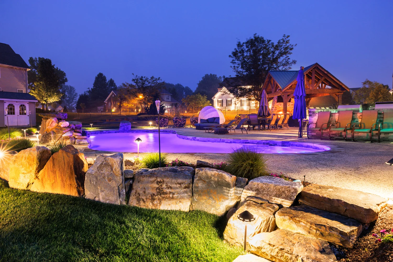 Pool area with fencing by Evergreen Hardscaping in Delaware