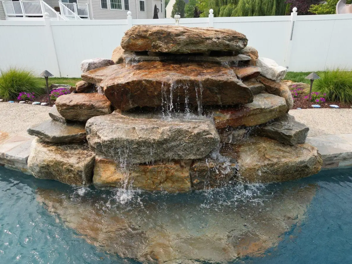 Fencing integrated with outdoor living space by Evergreen Hardscaping