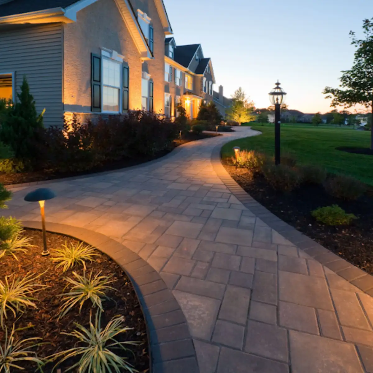 Professional landscape lighting illuminating a stone patio and garden in Delaware
