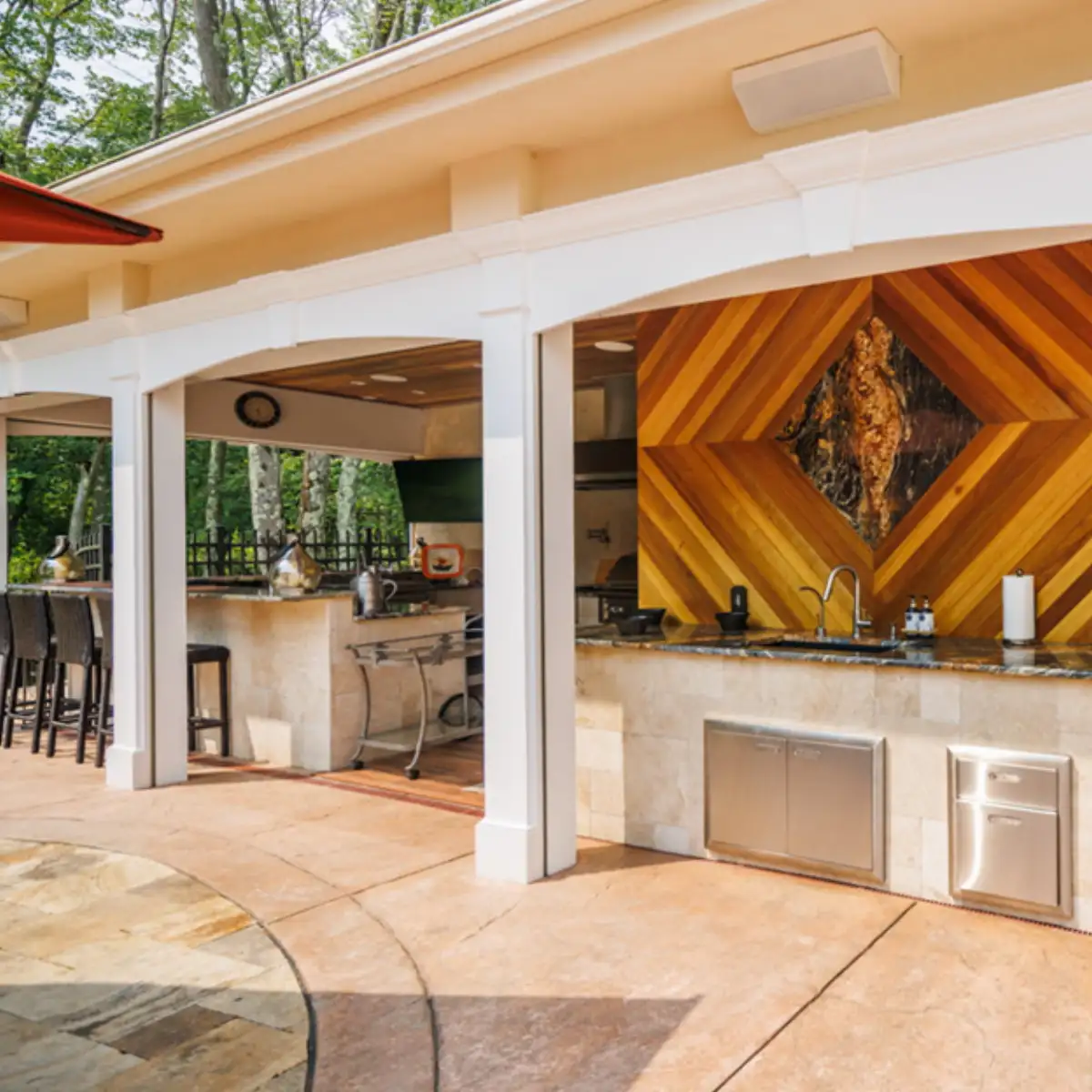 Custom outdoor kitchen with built-in grill and stone countertops