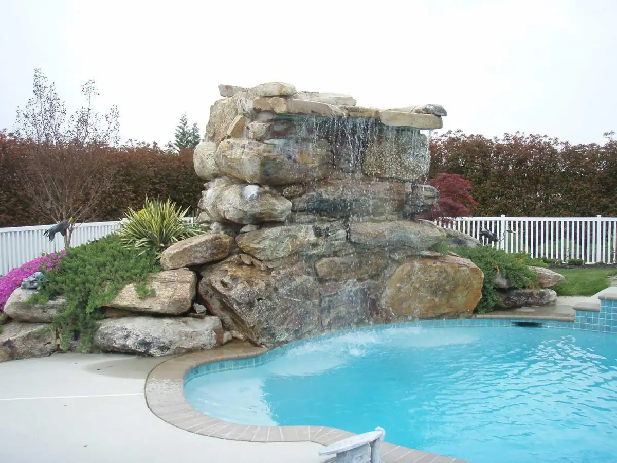 Custom pool with natural stone waterfall feature in Delaware